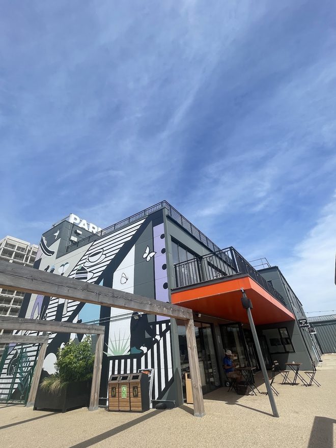 The striped frontage and orange canopy from the street